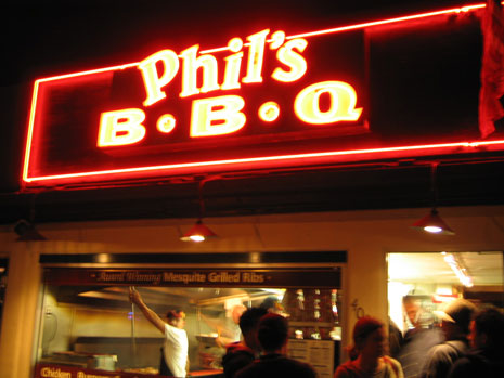 The front of Phil's BBQ at night